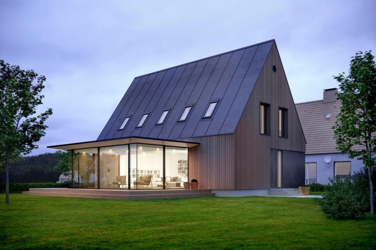 brunt hus med skraatak og frodig gress foran